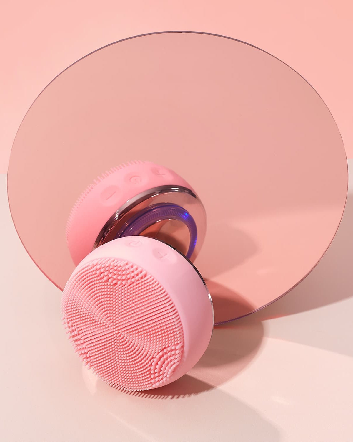A custom skincare SKIN GENIE PRO Cleansing Brush + LED Light Therapy sits on top of a IREN Shizen mirror, showcasing Japanese onsen skincare.
