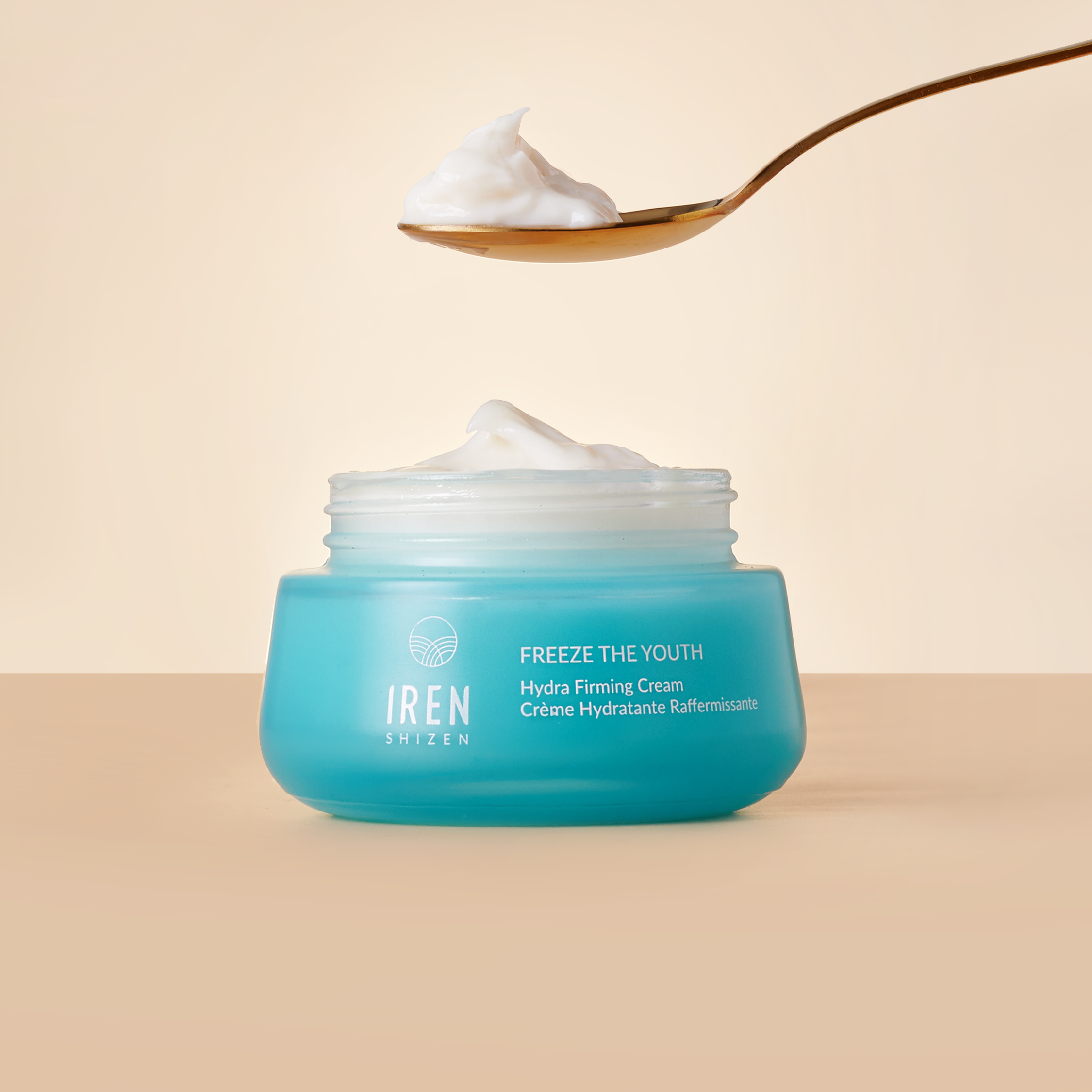 A spoon over a jar of FREEZE THE YOUTH Hydra Firming Cream from IREN Shizen. all-groups