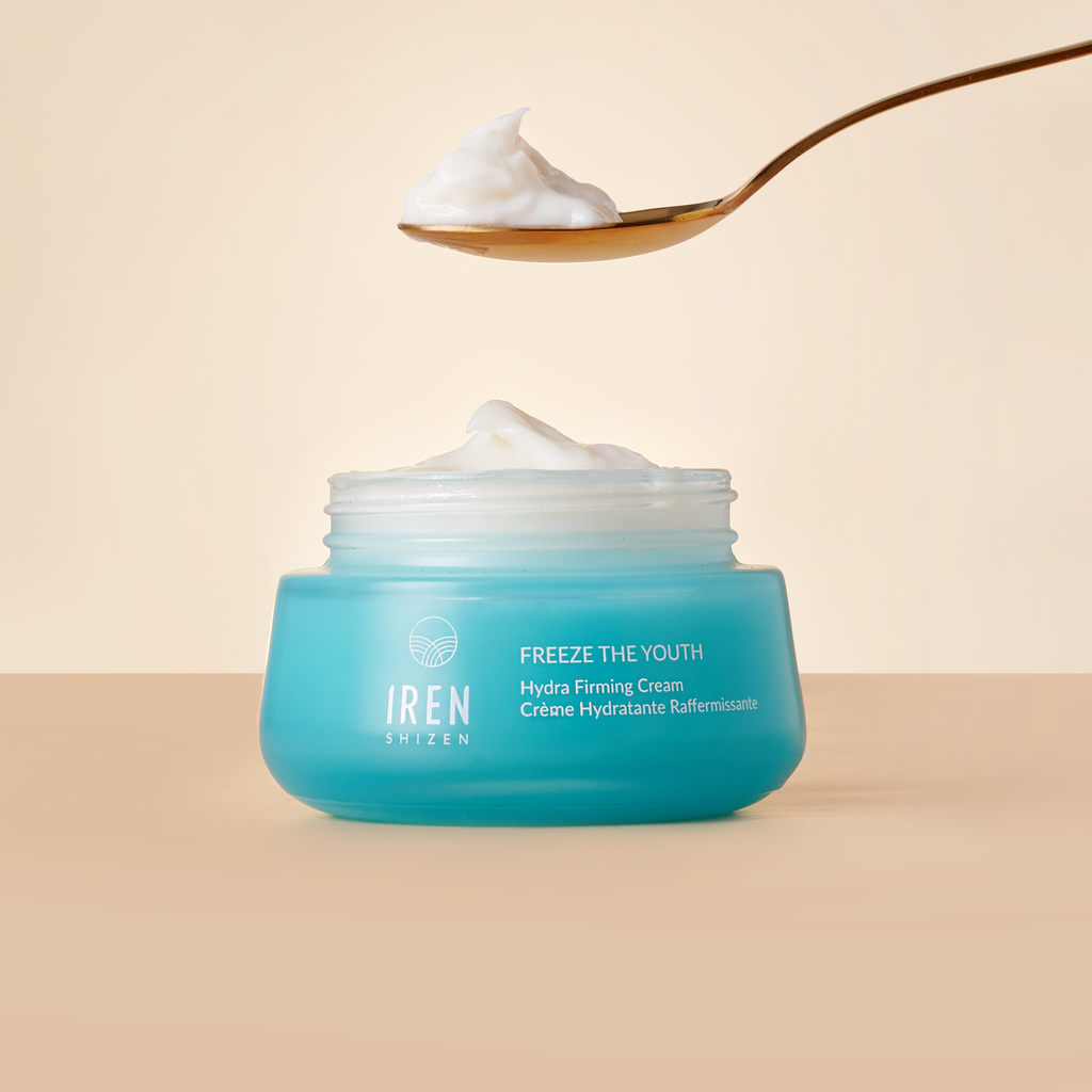 A spoon over a jar of FREEZE THE YOUTH Hydra Firming Cream from IREN Shizen.