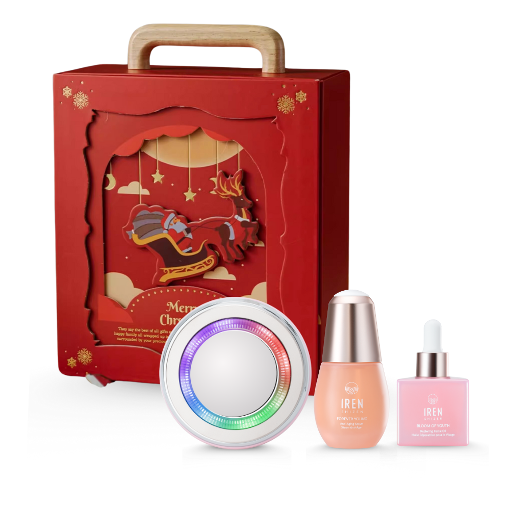 The CUSTOM XMAS For Special Ones Multi-Lift & Treat Gift Set by IREN Shizen is a festive red gift box, ideal for Christmas, featuring the innovative round Skin Genie Pro device for LED light therapy and two skincare bottles, one with a dropper.