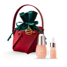 The CUSTOM XMAS For The Pals Serum Gift Set by IREN Shizen includes a red pouch with a green ribbon, featuring two skincare bottles—one with a pipette serum and the other with a cap. It comes with a gold "Merry Christmas" tag, making it the perfect gift box for the holiday season.