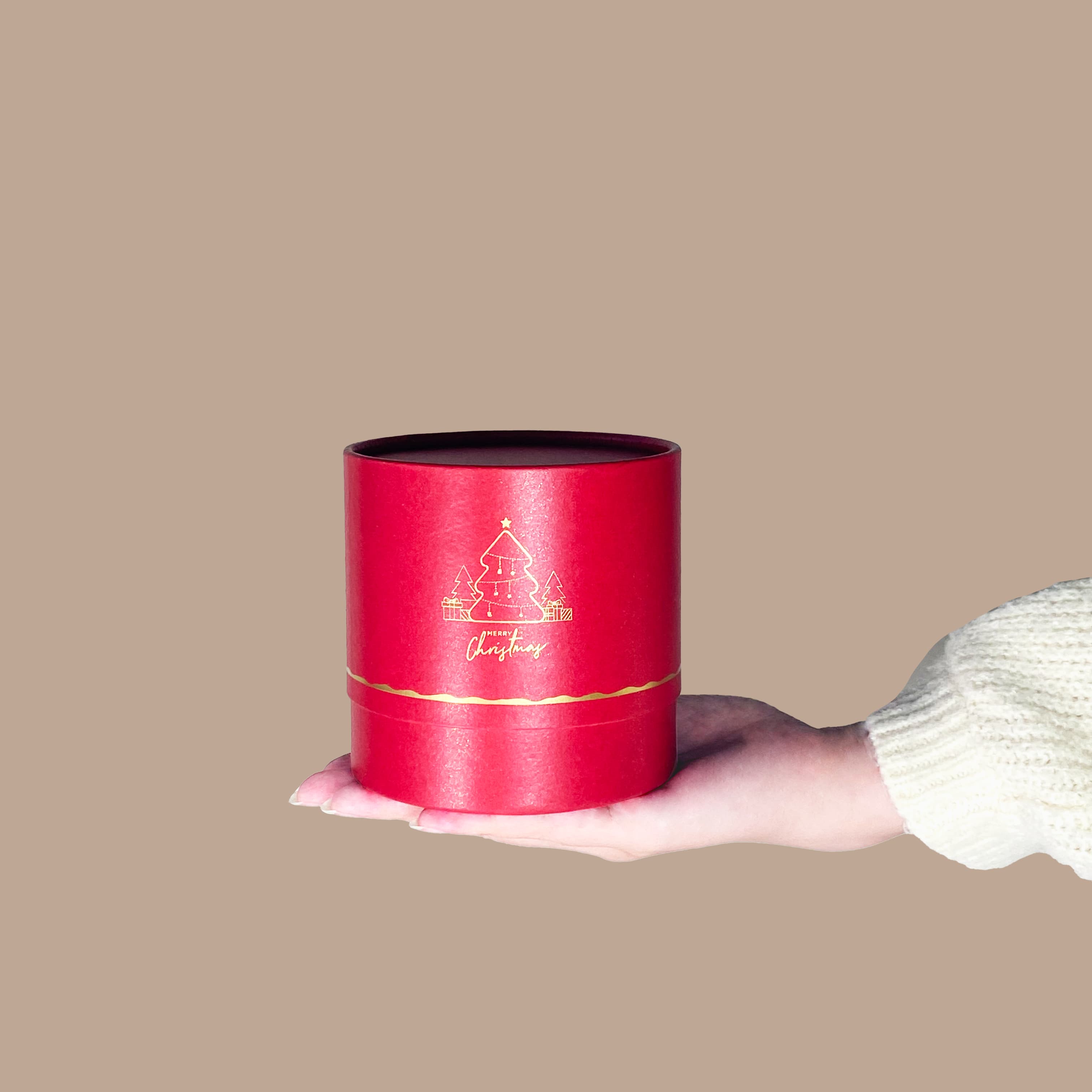 A hand holding a red tin container with gold foil, the CHRISTMAS GIFT SET For The Pals from IREN Shizen.