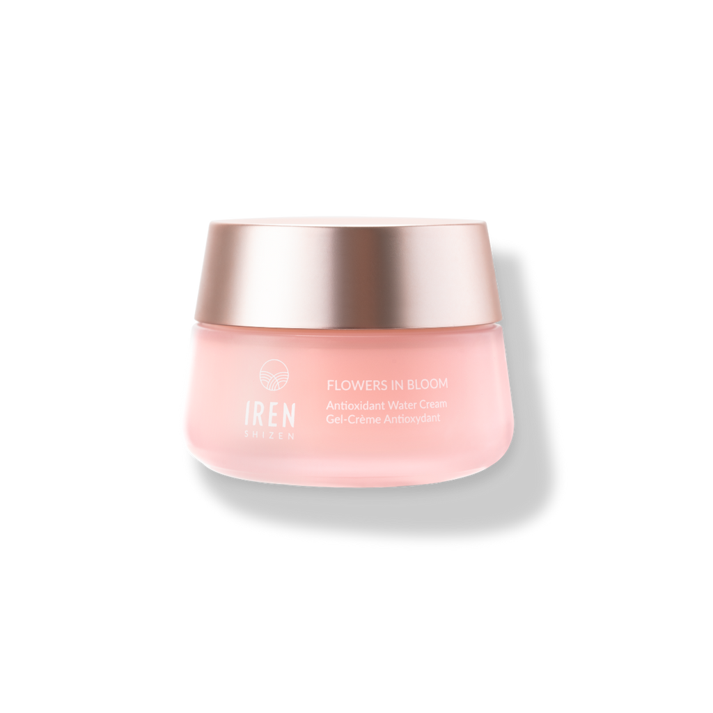 Rose-tinted cosmetic jar with metallic lid labeled "IREN Shizen FLOWERS IN BLOOM Antioxidant Water Cream" on a white background.