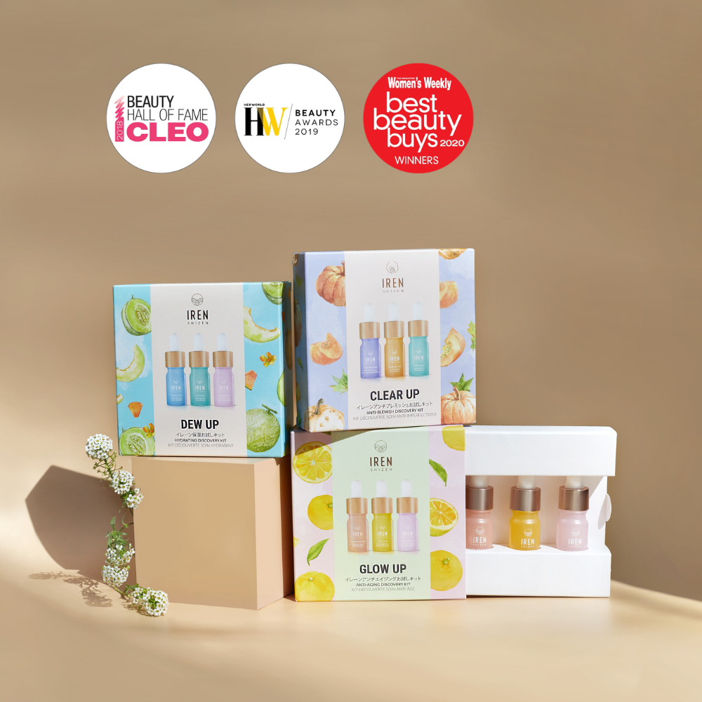 Four GLOW UP Anti-Aging Discovery Kits by IREN Shizen—each with three mini bottles—are displayed against a beige background, showcasing their Cleo, Her World, and Women's Weekly award badges above them.