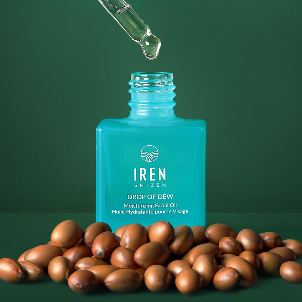 A bottle of IREN Shizen's DROP OF DEW Moisturizing Facial Oil, a customised Japanese skincare product, on a green background.
