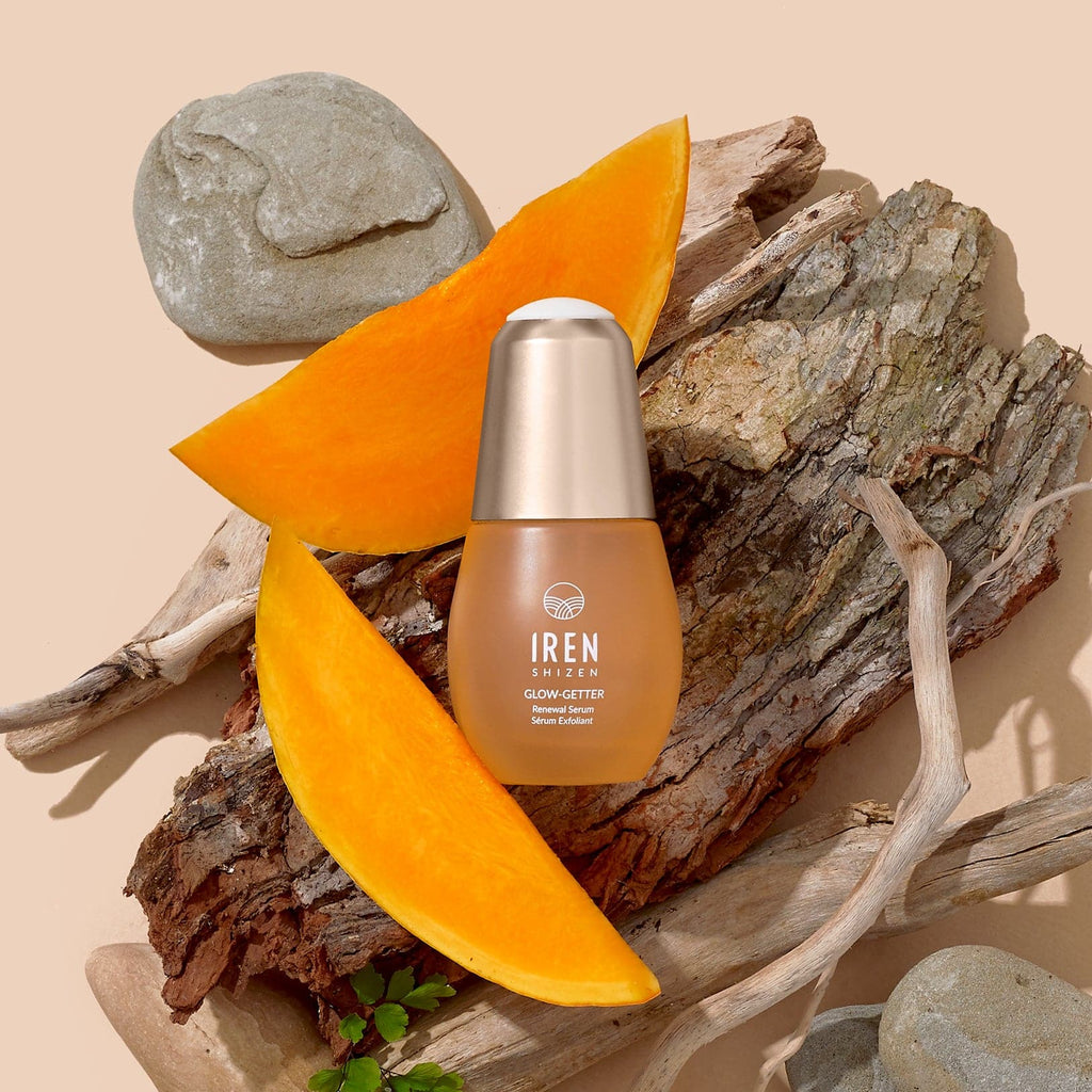 A bottle of customised Japanese skincare Glow-Getter Renewal Serum by IREN Shizen next to a slice of orange.